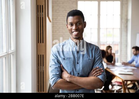 Millennial african staff member with arms crossed posing in office Stock Photo