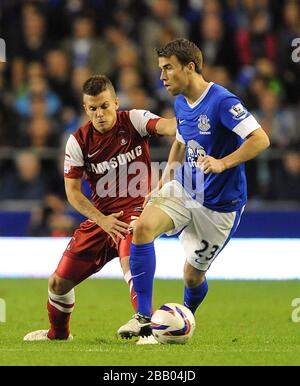 Leyton Orient's Dean Cox (left) and Everton's Seamus Coleman battle for the ball Stock Photo