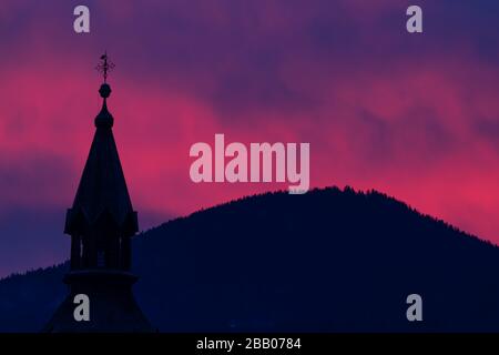 Pink sky over church in Bohinjska Bistrica Stock Photo
