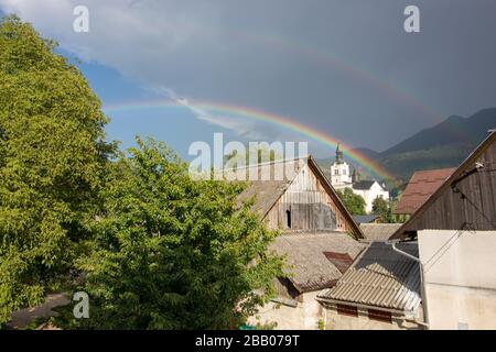Two rainbows over church in Bohinjska Bistrica Stock Photo