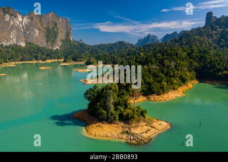 Aerial view of jungle-covered islands on a huge lake surrounded by limestone cliffs. (Cheow Lan Lake, Khao Sok, Thailand) Stock Photo