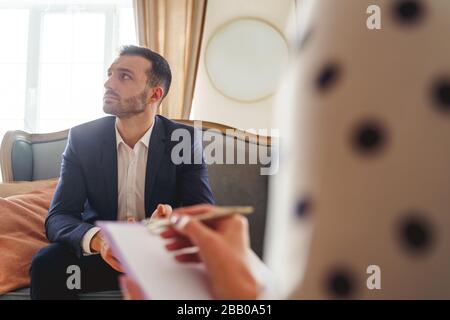 Frustrated man with a short haircut looking away Stock Photo