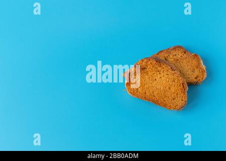 Crispy cracker on a blue background. Salty tea biscuits. Healthy Diet Snack. Stock Photo