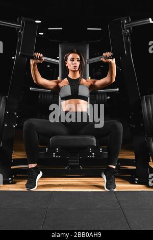 Slim, bodybuilder girl, does the exercises for arms in the gym. Sports  concept, fat burning and a healthy lifestyle Stock Photo - Alamy