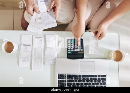 Adult daughter helping senior mother with bookkeeping and analyzing finances Stock Photo