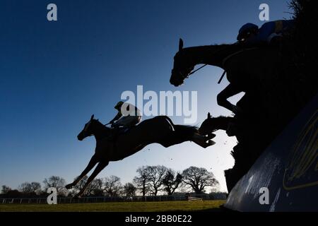 Horses are silhouetted during The William Hill - Download the app novices' handicap steeple chase  during day one of the 2013 William Hill Yorkshire Winter Festival, at Wetherby Racecourse. Stock Photo