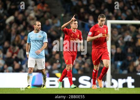Liverpool's Philippe Coutinho (centre) celebrates scoring their first goal of the game Stock Photo