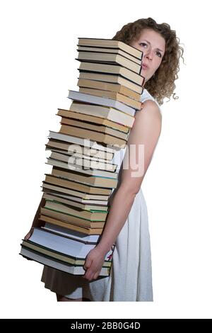 Cheerful student holding huge pile of books standing in library Stock ...