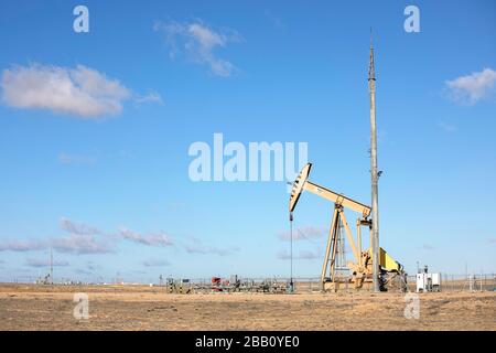 Pumping Oil on the coast at Caspian Sea, Aktau, Kazakhstan, bore oil crane pump Stock Photo