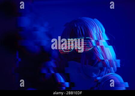 Girl with blaster in the futuristic battle. Concept virtual reality, cyber game and science fiction. Image with glitch effect. Stock Photo