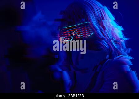 Girl with blaster in the futuristic battle. Concept virtual reality, cyber game and science fiction. Image with glitch effect. Stock Photo