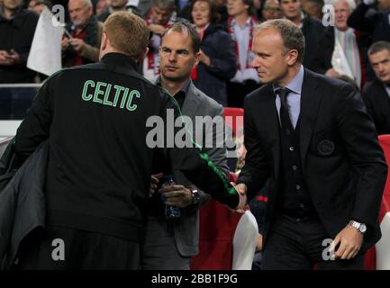 Celtic manager Neil Lennon (left) shakes hands with Ajax manager Frank de Boer (centre) and assistant manager Dennis Bergkamp Stock Photo