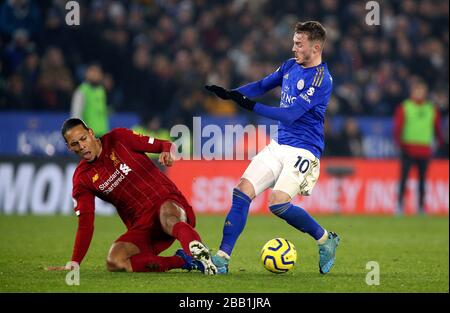 Liverpool's Virgil van Dijk and Leicester City's James Maddison (right) battle for the ball Stock Photo