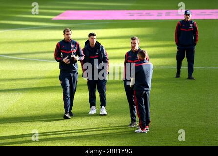 Arsenal players inspect the pitch prior to the beginning of the match Stock Photo