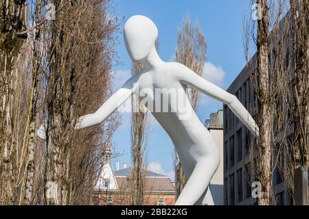 View on the so-called Walking Man (located at Leopoldstraße). Sculpture & symbol of Munich Re. Stock Photo