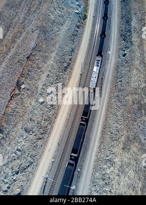 Aerial of export coal train over 120 wagons and 2km long destined for the coal export terminals of Gladstone Central Queensland Stock Photo