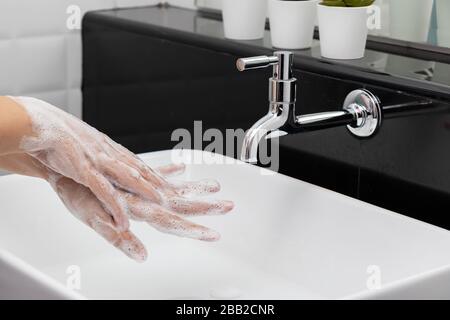 personal hygiene. washing hands, rubbing hand thoroughly with soap that has a lot of bubbles for cleaning and disinfection, prevention of spreading of Stock Photo