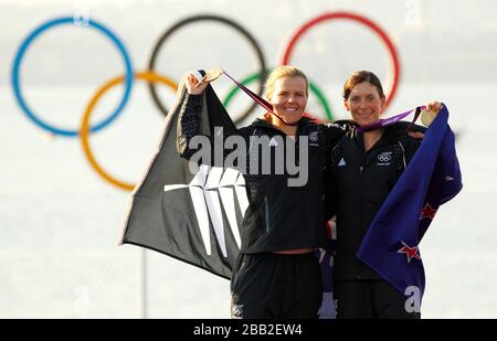 Gold medalists Jo Aleh and Olivia Powrie (left) from New Zealand during the medal ceremony at the Olympic sailing venue at Weymouth and Portland. Stock Photo