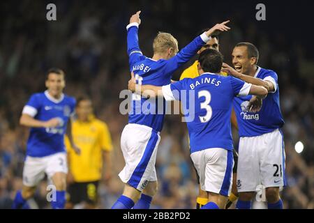 Everton's Tony Hibbert (left) is mobbed by teammates after scoring Stock Photo