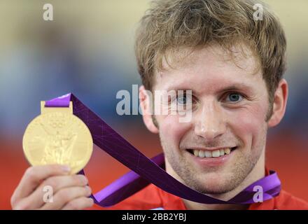 Great Britain's Jason Kenny celebrates with his gold medal after winning the Men's Sprint Final on day Ten of the Olympic Games at the Velodrome in London. Stock Photo