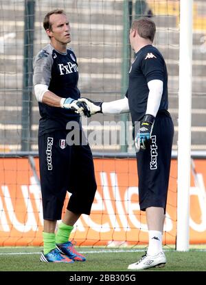 Fulham goalkeeper Mark Schwarzer shakes hands with team-mate David