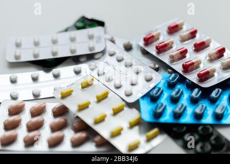 Pills and tablets in blisters. Top view. Various treatments mixed. Variety of pills and medication. Close up. Macro. Medical concept. Stock Photo