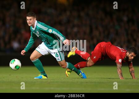 Northern Ireland's Oliver Norwood (left) evades a challenge by Portugal's Vieirinha Stock Photo