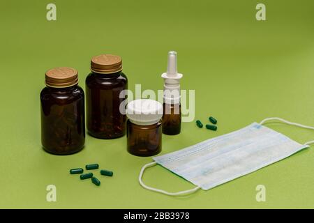 Various amber glass bottles for cosmetics, natural medicine, essential oils or capsules. Blurred green background and space for your text. Stock Photo