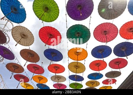 A display of umbrellas  at a temple in Thailand Stock Photo
