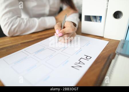 Woman draws up paper financial payment boards Stock Photo