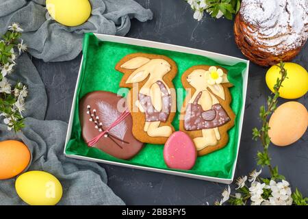 Easter gingerbread in the form of cute rabbits and eggs in a box on a dark background, Concept of the spring church holiday Stock Photo