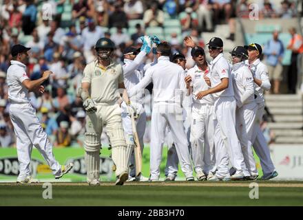 England's Jonathan Trott is congratulated after taking the catch of Australia's Chris Rogers (second left) off the bowling of Graeme Swann during day one of the Fifth Investec Ashes Test match at The Kia Oval, London. Stock Photo