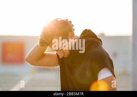 Young man exercising outdoors Stock Photo