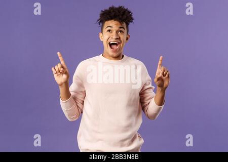 Charismatic good-looking young 25s hispanic guy rejoicing over super cool offer, best deal ever, seeing favorite product finally in stock, pointing Stock Photo