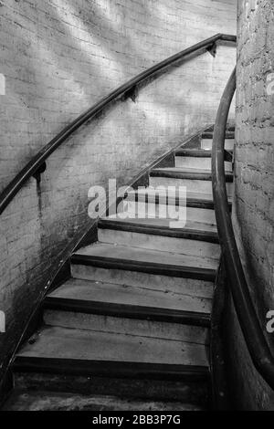 A municipal spiral stairway leading up to a public car parking lot. This image shows the stark municipal architecture of the 1960s. Stock Photo