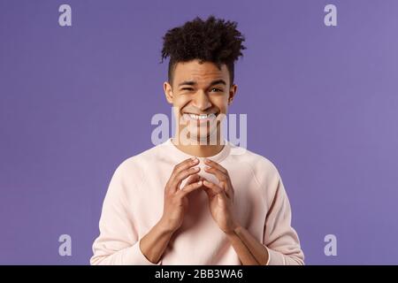 Portrait of creative young smart man with dreads, steeple fingers near chest and smirk devious, have perfect plan, scheming something for april fools Stock Photo