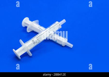 White 2 ml syringes close-up macro on white surface. Medicinal tool for ...