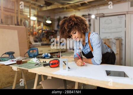 Afro american woman craftswoman working in her workshop Stock Photo