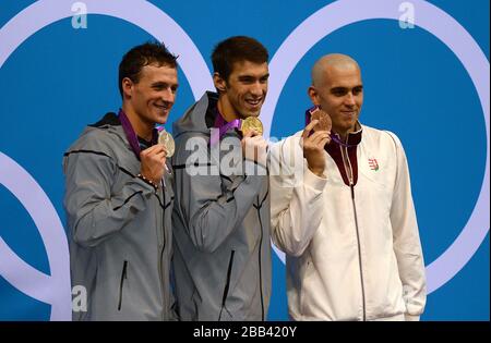 (left to right) Silver Medalist USA's Ryan Lochte, Gold Medalist USA's Michael Phelps and Bronze Medalist Hungary's Laszlo Cseh celebrate with their medals after the Men's 200m Individual Medley Stock Photo