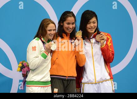 (left to right) Silver Medalist Belarus' Aliaksandra Herasimenia, Gold Medalist Netherlands' Ranomi Kromowidjojo and Bronze Medalist Yi Tang celebrate with their medals after the Women's 100m Freestyle Final at the Aquatics Centre in the Olympic Park, London. Stock Photo
