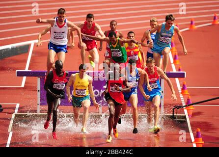 Competitors go over the water jump during heat 2 of Round 1 of the Men's 3000m Steeplechase Stock Photo