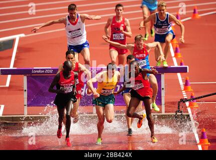 Competitors go over the water jump during heat 2 of Round 1 of the Men's 3000m Steeplechase Stock Photo