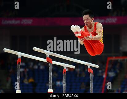 China's Weiyang Guo competes on the parallel bars during the Artistic Gymnastics team qualification at the North Greenwich Arena, London. Stock Photo