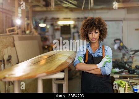 Afro american woman craftswoman working in her workshop Stock Photo