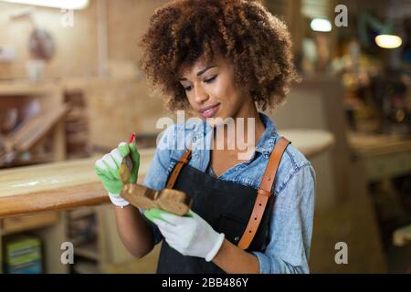 Afro american woman craftswoman working in her workshop Stock Photo