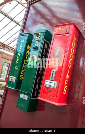 Close up of three vintage cigarette vending machines at Severn Valley  heritage railway station, UK Stock Photo