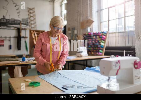Confident senior fashion designer in her workshop Stock Photo