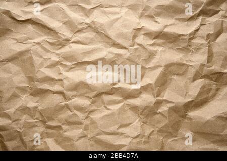 Old wrinkled brown craft paper poster texture. Blank creased