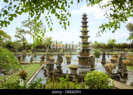 Tirtagangga royal gardens, Bali, Indonesia, with tiered fountain, fish ponds and stone causeway through pools Stock Photo