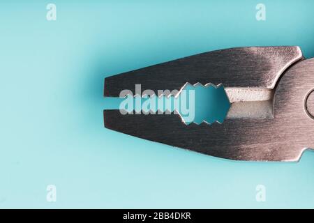 The multitool multi-function tool hovers on a blue background. The concept of an expanded multi-tool with free space. Stock Photo